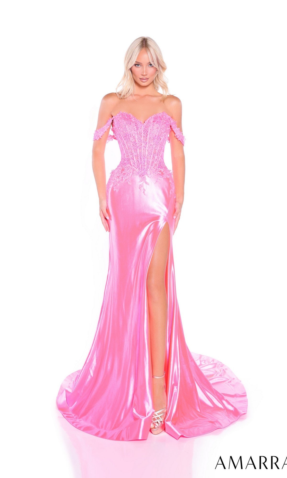 A woman models the Amarra 88978 Off-Shoulder Long Corset Prom Gown in shiny pink, featuring a high slit, fitted bodice, and floor-length train, posed against a plain white background.